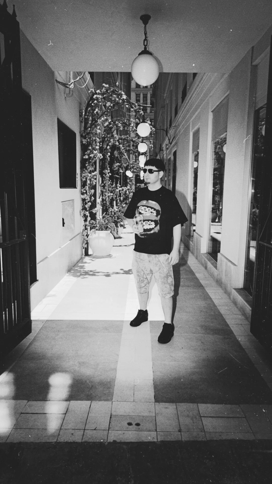 Max Gotham standing in a black-and-white hallway